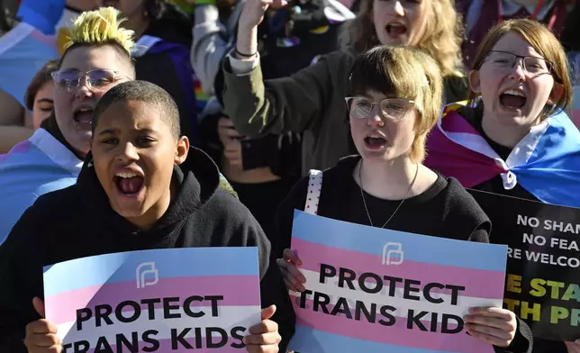 FILE - Protesters of Kentucky Senate Bill SB150, known as the Transgender Health Bill, cheer on speakers during a rally on the lawn of the Kentucky Capitol in Frankfort, Ky., March 29, 2023. (AP Photo/Timothy D. Easley, File)