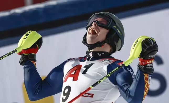 Sweden's Kristoffer Jakobsen celebrates at the finish area of an alpine ski, men's World Cup slalom, in Gurgl, Austria, Sunday, Nov. 24, 2024. (AP Photo/Gabriele Facciotti)