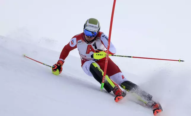 Austria's Manuel Feller speeds down the course during an alpine ski, men's World Cup slalom, in Gurgl, Austria, Sunday, Nov. 24, 2024. (AP Photo/Giovanni Maria Pizzato)