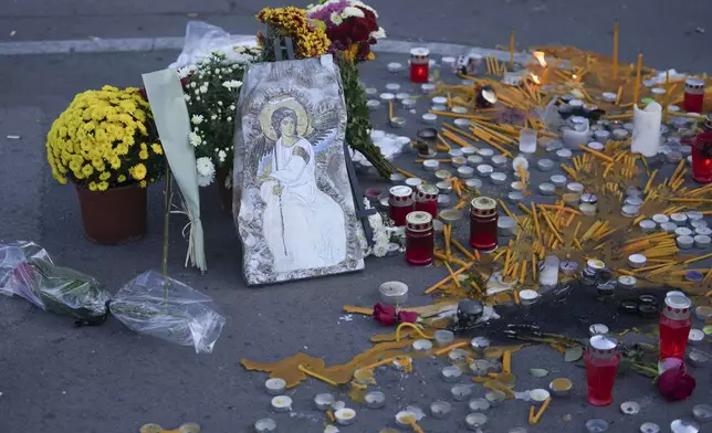 An Orthodox icon and candles for the victims after an outdoor roof collapsed at a train station in Novi Sad, Serbia, Saturday, Nov. 2, 2024. (AP Photo/Darko Vojinovic)