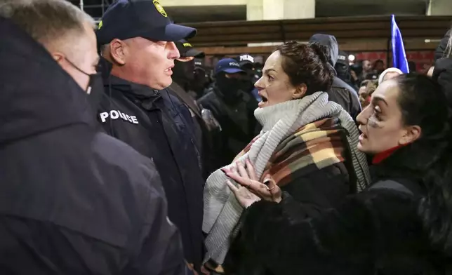 Women argue with police officers during a rally against the results of the parliamentary elections amid allegations that the vote was rigged in Tbilisi, Georgia Tuesday, Nov. 19, 2024. (AP Photo/Zurab Tsertsvadze)