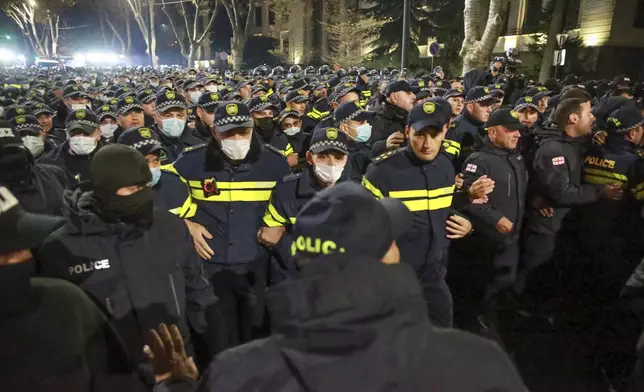 Police block a street during a rally against the results of the parliamentary elections amid allegations that the vote was rigged in Tbilisi, Georgia Tuesday, Nov. 19, 2024. (AP Photo/Zurab Tsertsvadze)