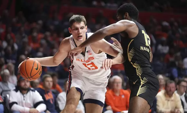 Illinois's Tomislav Ivisic (13) drives to the basket as Oakland's Tuburu Naivalurua defends during the first half of an NCAA college basketball game Wednesday, Nov. 13, 2024, in Champaign, Ill. (AP Photo/Charles Rex Arbogast)