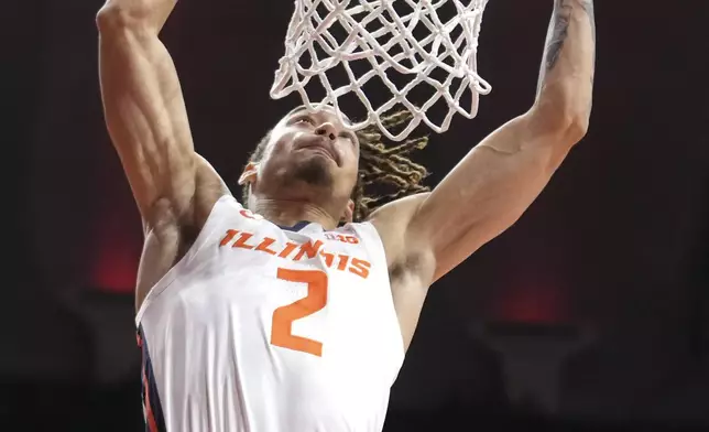 Illinois's Dra Gibbs-Lawhorn dunks the ball during the first half of an NCAA college basketball game against Oakland on Wednesday, Nov. 13, 2024, in Champaign, Ill. (AP Photo/Charles Rex Arbogast)