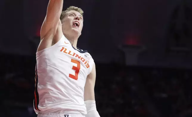 Illinois's Ben Humrichous dunks the ball during the first half of an NCAA college basketball game against Oakland on Wednesday, Nov. 13, 2024, in Champaign, Ill. (AP Photo/Charles Rex Arbogast)