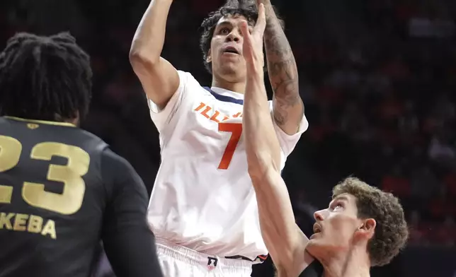 Illinois's Will Riley shoots over Oakland's Malcolm Christie during the first half of an NCAA college basketball game Wednesday, Nov. 13, 2024, in Champaign, Ill. (AP Photo/Charles Rex Arbogast)