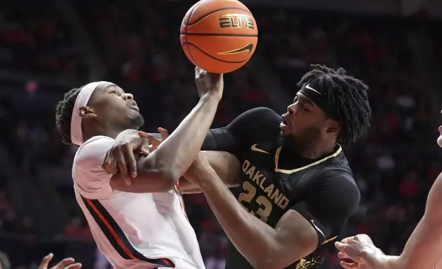 Illinois's Morez Johnson Jr., left, and Oakland's Allen Mukeba battle for a rebound during the first half of an NCAA college basketball game Wednesday, Nov. 13, 2024, in Champaign, Ill. (AP Photo/Charles Rex Arbogast)