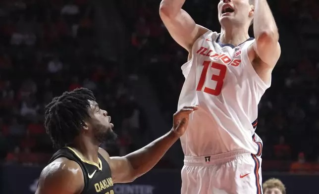 Illinois's Tomislav Ivisic (13) shoots over Oakland's Allen Mukeba during the first half of an NCAA college basketball game Wednesday, Nov. 13, 2024, in Champaign, Ill. (AP Photo/Charles Rex Arbogast)