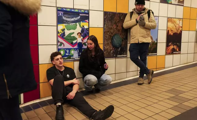 People take shelter in a metro station as a siren sounds a warning of incoming rockets from Lebanon in Haifa, Tuesday, Nov. 26, 2024. (AP Photo/Francisco Seco)