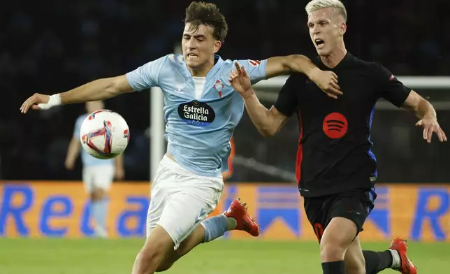 Celta's Javi Rodriguez, left, and Barcelona's Dani Olmo fight for the ball during the Spanish La Liga soccer match between Celta Vigo and Barcelona at the Balaidos stadium in Vigo, Spain, Saturday, Nov. 23, 2024. (AP Photo/Lalo R. Villar)