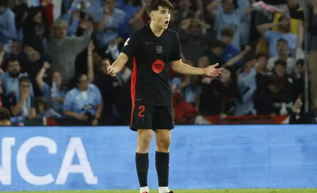 Barcelona's Pau Cubarsi reacts after Celta's Hugo Alvarez scored during the Spanish La Liga soccer match between Celta Vigo and Barcelona at the Balaidos stadium in Vigo, Spain, Saturday, Nov. 23, 2024. (AP Photo/Lalo R. Villar)