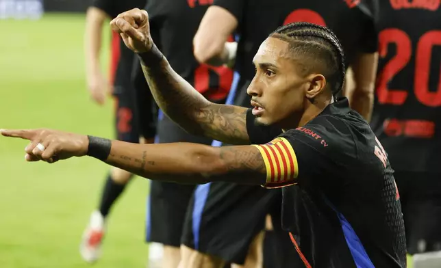 Barcelona's Raphinha celebrates scoring his side's opening goal during the Spanish La Liga soccer match between Celta Vigo and Barcelona at the Balaidos stadium in Vigo, Spain, Saturday, Nov. 23, 2024. (AP Photo/Lalo R. Villar)