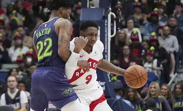 Toronto Raptors guard RJ Barrett (9) drives down court against New Orleans Pelicans guard Elfrid Payton (22) in the first half of an NBA basketball game in New Orleans, Wednesday, Nov. 27, 2024. (AP Photo/Gerald Herbert)