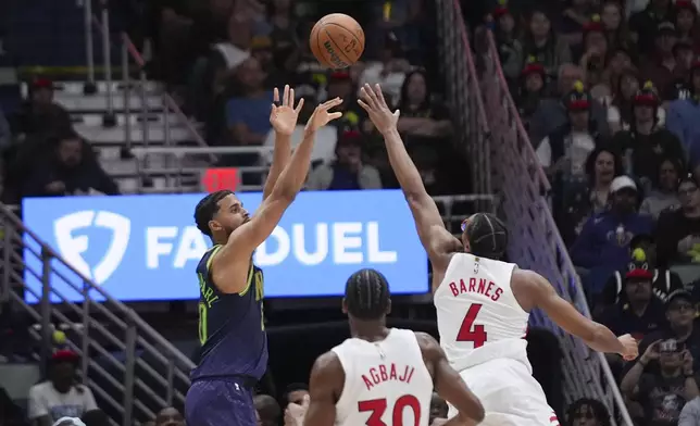 New Orleans Pelicans forward Jeremiah Robinson-Earl shoots against Toronto Raptors forward Scottie Barnes (4) in the first half of an NBA basketball game in New Orleans, Wednesday, Nov. 27, 2024. (AP Photo/Gerald Herbert)