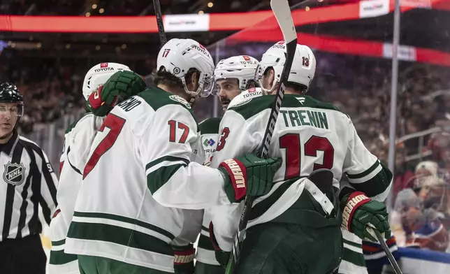 Minnesota Wild players celebrate after a goal against the Edmonton Oilers during third-period NHL hockey game action in Edmonton, Alberta, Thursday, Nov. 21, 2024. (Jason Franson/The Canadian Press via AP)