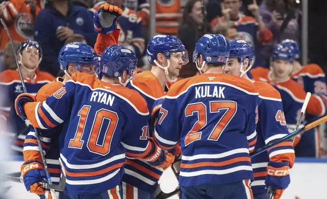 Edmonton Oilers' Corey Perry, center, celebrates after a goal with teammates during second-period NHL hockey game action against the Minnesota Wild in Edmonton, Alberta, Thursday, Nov. 21, 2024. (Jason Franson/The Canadian Press via AP)