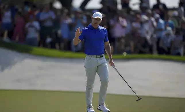 Rory McIlroy of Northern Ireland acknowledges the crowd after scoring a birdie on the 9th green in the final round of World Tour Golf Championship in Dubai, United Arab Emirates, Sunday, Nov. 17, 2024. (AP Photo/Altaf Qadri)