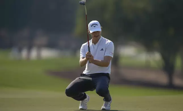 Rasmus Højgaard of Denmark reacts after missing a shot on the 9th green in the final round of World Tour Golf Championship in Dubai, United Arab Emirates, Sunday, Nov. 17, 2024. (AP Photo/Altaf Qadri)