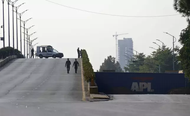 Paramilitary soldiers patrol as they station at a overhead bridge ahead of a planned rally by supporters of imprisoned former Prime Minister Imran Khan's Pakistan Tehreek-e-Insaf party, in Islamabad, Pakistan, Sunday, Nov. 24, 2024. (AP Photo/Anjum Naveed)