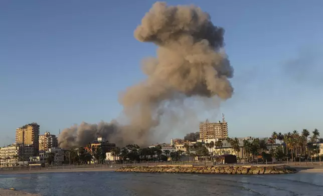 Smoke rises from a building hit in an Israeli airstrike in Tyre, southern Lebanon, Saturday, Nov. 16, 2024. (AP Photo/Mohammed Zaatari)