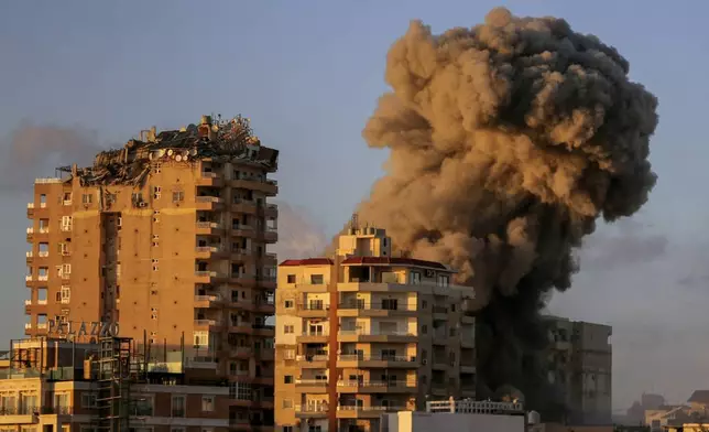 Smoke rises from a building hit in an Israeli airstrike in Tyre, southern Lebanon, Saturday, Nov. 16, 2024. (AP Photo/Mohammed Zaatari)