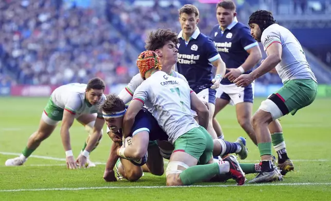 Scotland's Ben Muncaster, left, is tackled during the Autumn Nations series rugby union match between Scotland and Portugal at the Scottish Gas Murrayfield Stadium, in Edinburgh, Scotland, Saturday Nov. 16, 2024. (Jane Barlow/PA via AP)