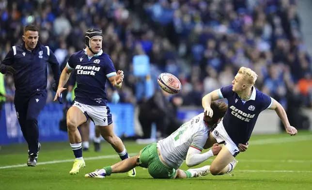 Scotland's Arron Reed, right, passes the ball to team-mate Darcy Graham to score his side's fourth try of the game during the Autumn Nations series rugby union match between Scotland and Portugal at the Scottish Gas Murrayfield Stadium, in Edinburgh, Scotland, Saturday Nov. 16, 2024. (Jane Barlow/PA via AP)