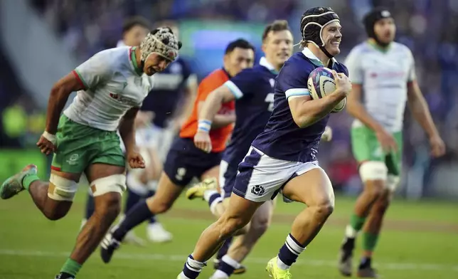 Scotland's Darcy Graham breaks free to score his side's fourth try of the game during the Autumn Nations series rugby union match between Scotland and Portugal at the Scottish Gas Murrayfield Stadium, in Edinburgh, Scotland, Saturday Nov. 16, 2024. (Jane Barlow/PA via AP)