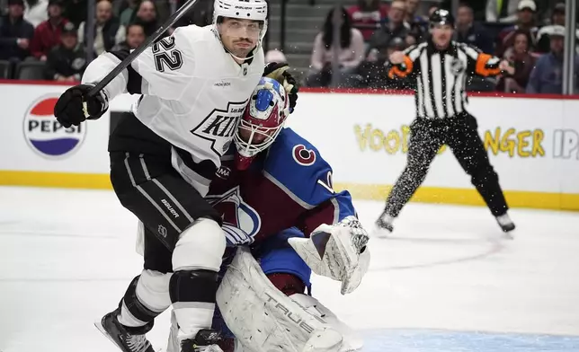 Los Angeles Kings left wing Kevin Fiala, left, avoids Colorado Avalanche goaltender Alexandar Georgiev after he stopped a shot off Fiala's stick in the second period of an NHL hockey game Wednesday, Nov. 13, 2024, in Denver. (AP Photo/David Zalubowski)