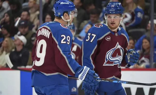 Colorado Avalanche center Nathan MacKinnon, left, confers with center Casey Mittelstadt in the first period of an NHL hockey game against the Los Angeles Kings Wednesday, Nov. 134, 2024, in Denver. (AP Photo/David Zalubowski)