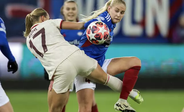 München's Klara Buehl, left, and Valerenga's Iselin Olsen, right, challenge for the ball during the Women's Champions League, group C, soccer match between Valerenga and FC Bayern Munich in Oslo, Norway, Thursday, Nov. 21, 2024. (Jonas Been Henriksen/NTB Scanpix via AP)