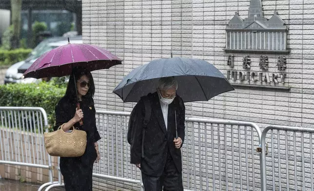 Jimmy Lai's wife Teresa Lai, left, and retired Chinese cardinal Joseph Zen Ze-Kiun arrive at West Kowloon Magistrates' Courts to attend Hong Kong activist publisher Lai's national security trial in Hong Kong, Wednesday, Nov. 20, 2024. (AP Photo/Chan Long Hei)