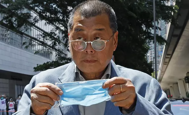 Hong Kong media tycoon Jimmy Lai, who founded local newspaper Apple Daily, is about to wear a face mask before entering a court in Hong Kong on May 5, 2020. (AP Photo/Kin Cheung, File)