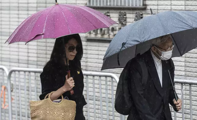 Jimmy Lai's wife Teresa Lai, left, and retired Chinese cardinal Joseph Zen Ze-Kiun arrive at West Kowloon Magistrates' Courts to attend Hong Kong activist publisher Lai's national security trial in Hong Kong, Wednesday, Nov. 20, 2024. (AP Photo/Chan Long Hei)