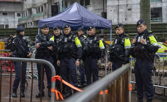 Police stand guard outside the West Kowloon Magistrates' Courts in Hong Kong, Wednesday, Nov. 20, 2024. (AP Photo/Chan Long Hei)