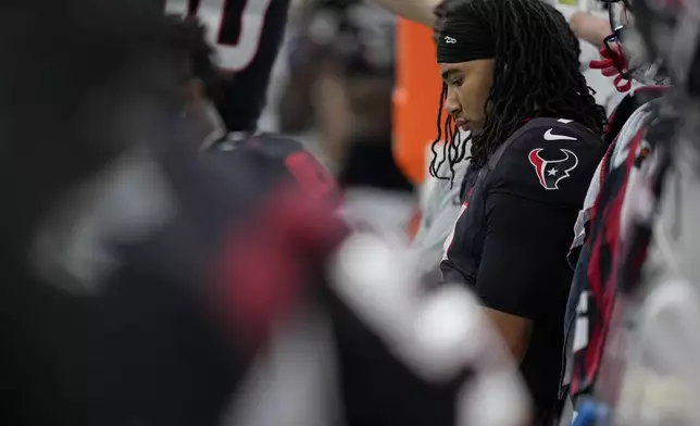 Houston Texans quarterback C.J. Stroud sits on the bench late in the second half an NFL football game against the Tennessee Titans, Sunday, Nov. 24, 2024, in Houston. (AP Photo/Ashley Landis)