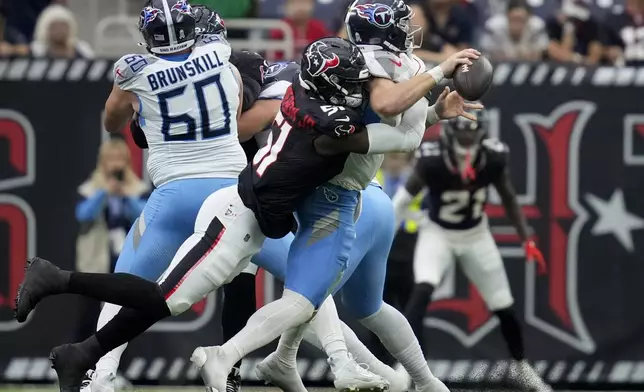 Houston Texans defensive end Will Anderson Jr., left, sacks Tennessee Titans quarterback Will Levis, right, during the first half of an NFL football game Sunday, Nov. 24, 2024, in Houston. (AP Photo/Ashley Landis)