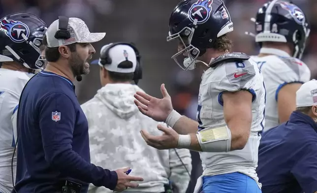 Tennessee Titans head coach Brian Callahan, left, talks to quarterback Will Levis, right, during the first half of an NFL football game against the Houston Texans, Sunday, Nov. 24, 2024, in Houston. (AP Photo/Eric Christian Smith)