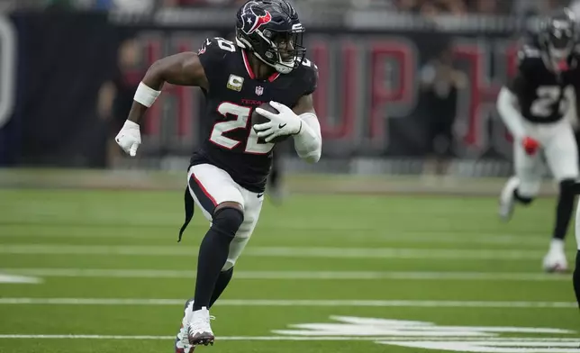 Houston Texans safety Jimmie Ward (20) returns an interception for a touchdown during the second half an NFL football game against the Tennessee Titans, Sunday, Nov. 24, 2024, in Houston. (AP Photo/Ashley Landis)