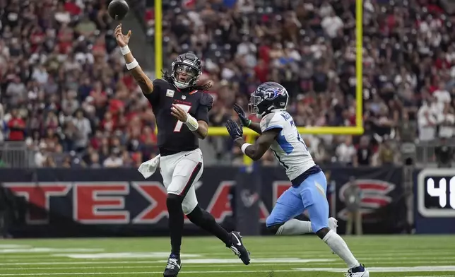 Houston Texans quarterback C.J. Stroud (7) throws a pass as he is pressured by Tennessee Titans cornerback Roger McCreary, right, during the first half of an NFL football game Sunday, Nov. 24, 2024, in Houston. (AP Photo/Ashley Landis)