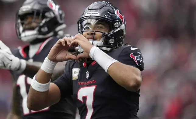 Houston Texans quarterback C.J. Stroud (7) celebrates a touchdown during the first half of an NFL football game against the Tennessee Titans, Sunday, Nov. 24, 2024, in Houston. (AP Photo/Ashley Landis)