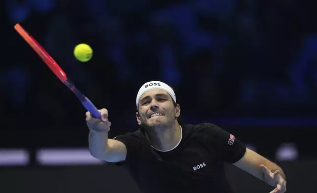 United States' Taylor Fritz returns the ball to Australia's Alex de Minaur during their singles tennis match of the ATP World Tour Finals at the Inalpi Arena, in Turin, Italy, Thursday, Nov. 14, 2024. (AP Photo/Antonio Calanni)