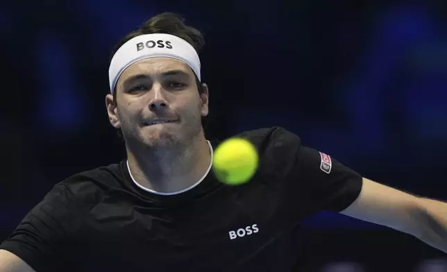 United States' Taylor Fritz returns the ball to Australia's Alex de Minaur during their singles tennis match of the ATP World Tour Finals at the Inalpi Arena, in Turin, Italy, Thursday, Nov. 14, 2024. (AP Photo/Antonio Calanni)