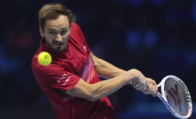 Russia's Daniil Medvedev returns the ball to Italy's Jannik Sinner during their singles tennis match of the ATP World Tour Finals at the Inalpi Arena, in Turin, Italy, Thursday, Nov. 14, 2024. (AP Photo/Antonio Calanni)