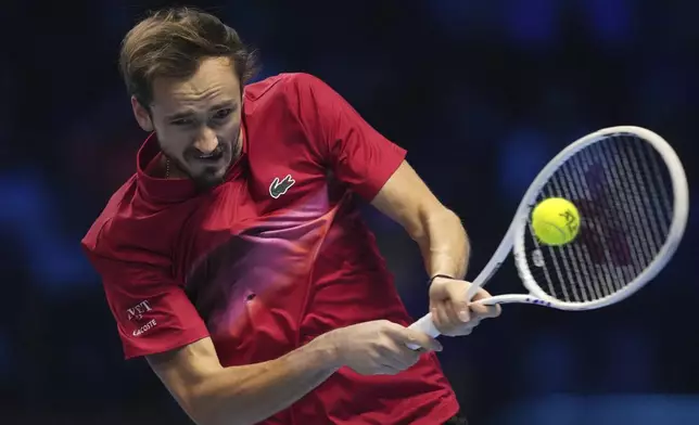 Russia's Daniil Medvedev returns the ball to Italy's Jannik Sinner during their singles tennis match of the ATP World Tour Finals at the Inalpi Arena, in Turin, Italy, Thursday, Nov. 14, 2024. (AP Photo/Antonio Calanni)