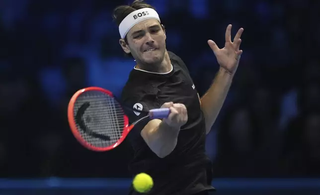 United States' Taylor Fritz returns the ball to Australia's Alex de Minaur during their singles tennis match of the ATP World Tour Finals at the Inalpi Arena, in Turin, Italy, Thursday, Nov. 14, 2024. (AP Photo/Antonio Calanni)