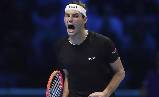 United States' Taylor Fritz reacts after winning a point against Australia's Alex de Minaur during their singles tennis match of the ATP World Tour Finals at the Inalpi Arena, in Turin, Italy, Thursday, Nov. 14, 2024. (AP Photo/Antonio Calanni)