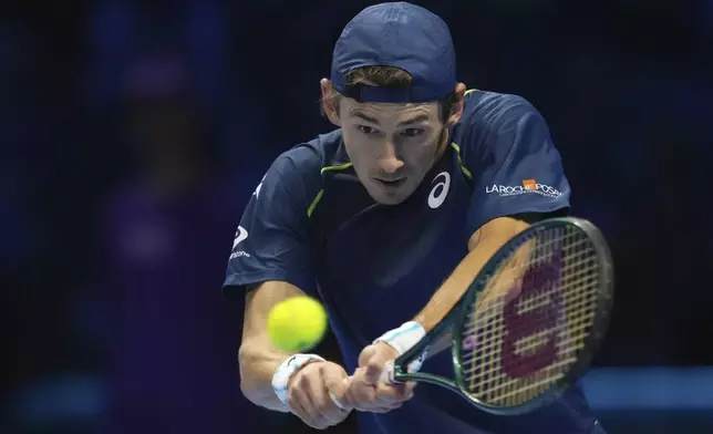 Australia's Alex de Minaur returns the ball to United States' Taylor Fritz during their singles tennis match of the ATP World Tour Finals at the Inalpi Arena, in Turin, Italy, Thursday, Nov. 14, 2024. (AP Photo/Antonio Calanni)