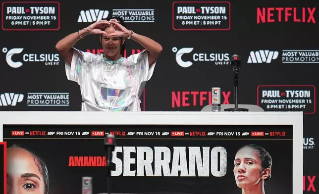 Amanda Serrano gestures during a news conference ahead of her undisputed super lightweight world title bout against Katie Taylor, the co-main event in the Mike Tyson vs. Jake Paul fight night, Wednesday, Nov. 13, 2024, in Irving, Texas. (AP Photo/Julio Cortez)