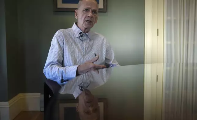 Michael Sullivan, 64, of Lowell, Mass., who was convicted of murder and armed robbery in 1987 and spend years in jail before being ruled innocent, speaks to a reporter from The Associated Press at his attorney's office, Wednesday, Nov. 20, 2024, in Framingham, Mass. (AP Photo/Steven Senne)